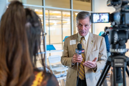 Wyoming Governor Mark Gordon discusses the new supercomputer with a reporter