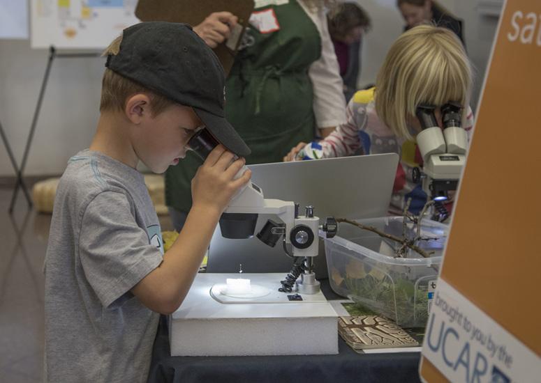 A child looks through a microscope
